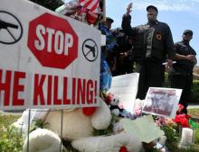 Mikhail Muhammad, center, leads a protest by the New Black Panther Party on Sat.